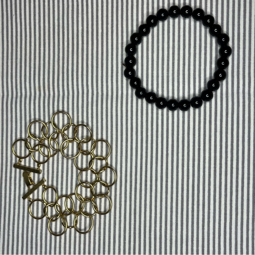black beaded bracelet and gold rings bracelet